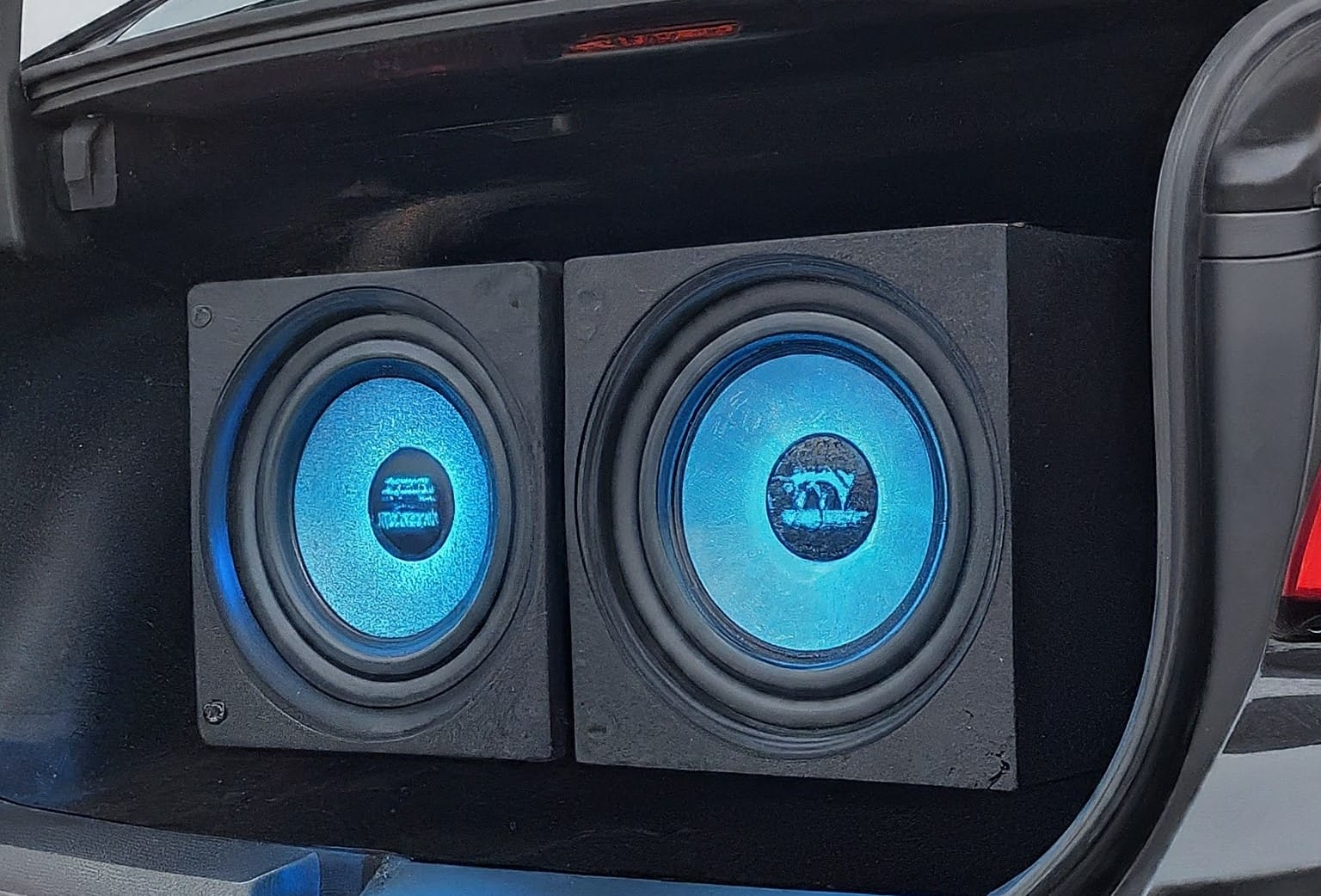 Powerful car subwoofer in trunk with blue LED lights